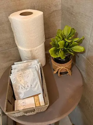 a table with a roll of toilet paper and a plant at Loft Ballarò in Palermo