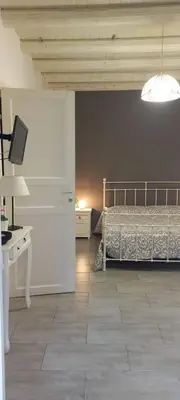 a bedroom with a bed and a desk and a lamp at Loft Ballarò in Palermo