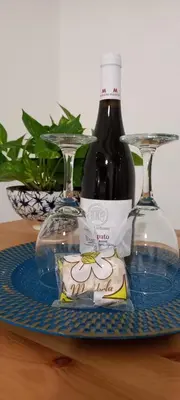 a bottle of wine and two glasses on a table at Loft Ballarò in Palermo
