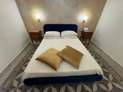 a bed with two pillows on it in a room at Belvedere Suite in Termini Imerese