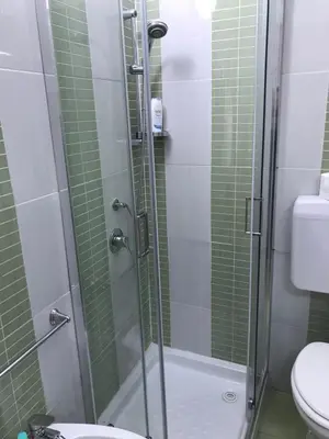 a bathroom with a glass shower with a toilet at Busalacchi B&B in Mondello