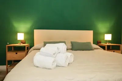 a bedroom with a large bed with towels on it at Ai Tintori in Palermo