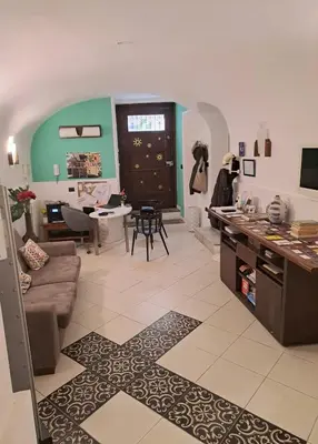 a living room with a couch and a table at Ai Tintori in Palermo