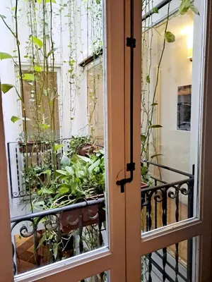 an open door with a balcony with plants at Ai Tintori in Palermo