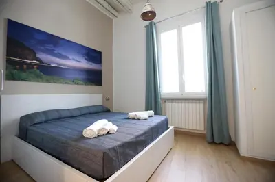 a bedroom with a bed with towels on it at La Casetta delle Scienze Suite in Palermo