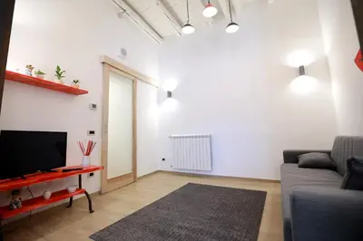 a living room with a couch and a television at La Casetta delle Scienze Suite in Palermo