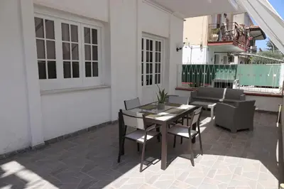 a patio with a table and chairs on a building at Casa Costanzo in Capaci