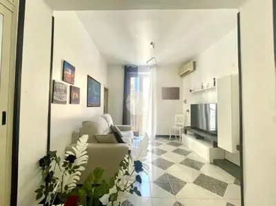 a living room with a couch and a television at Casa Cristy palermo in Palermo