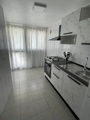 a white kitchen with a stove and a sink at Casa Cristy palermo in Palermo
