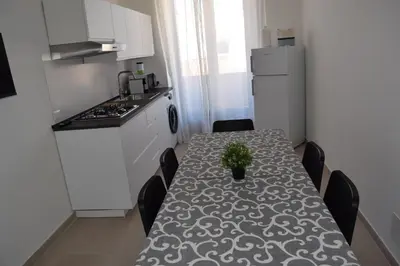 a small kitchen with a table with a plant on it at Domus Ponente in Terrasini