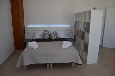 a bedroom with a bed with two towels on it at Domus Ponente in Terrasini