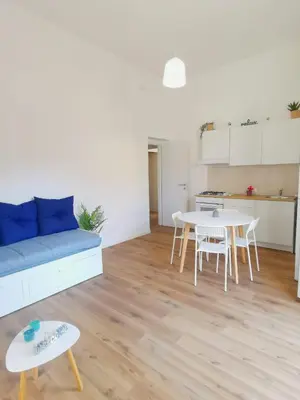 a living room with a blue couch and a table at Mondello sicily apartament in Mondello