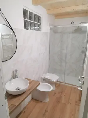 a bathroom with a toilet and a sink and a shower at Mondello sicily apartament in Mondello