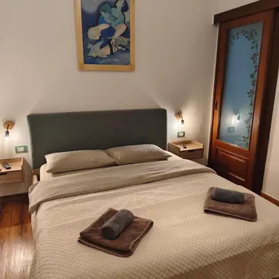 a bedroom with a bed with two towels on it at Casa Sedie Volanti in Palermo