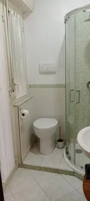 a bathroom with a toilet and a glass shower at Casa Sedie Volanti in Palermo