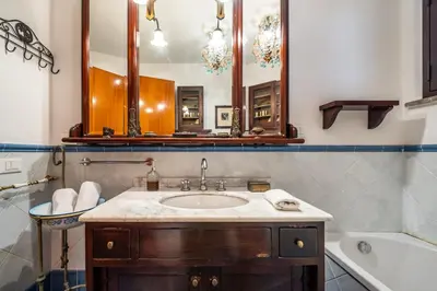 a bathroom with a sink and a toilet and a mirror at A pochi passi dal mare in Mondello