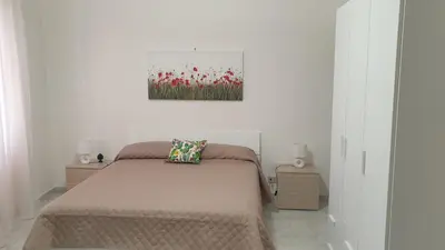 a bedroom with a bed and a painting on the wall at Casa Vacanze San Martino in Corleone
