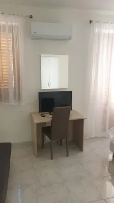 a desk with a chair and a computer in a room at Casa Vacanze San Martino in Corleone