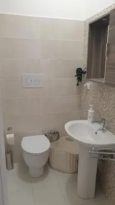 a white bathroom with a toilet and a sink at Casa Vacanze San Martino in Corleone