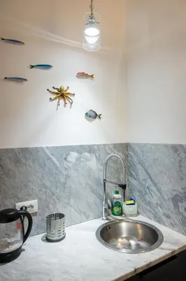 a bathroom with a sink and a washing machine at Faboulous Flat in Palermo