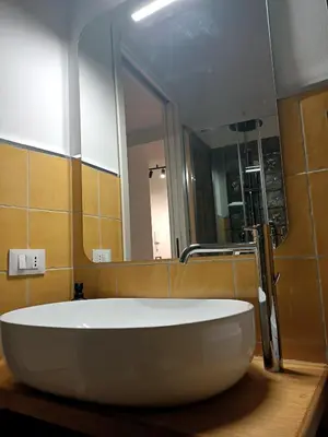 a large white tub in a bathroom with a mirror at Sofia Holiday Home in Palermo