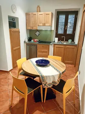 a kitchen with a table and chairs with a bowl on it at Sofia Holiday Home in Palermo