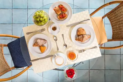 a table with plates of food on top of it at Hotel La Piazzetta in Castellammare del Golfo