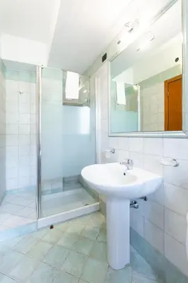 a bathroom with a sink and a shower at Hotel La Piazzetta in Castellammare del Golfo