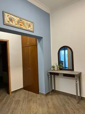 a room with a table and a mirror and a door at Allegracori Appartamenti in Castellammare del Golfo