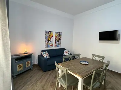 a living room with a table and a couch at Allegracori Appartamenti in Castellammare del Golfo