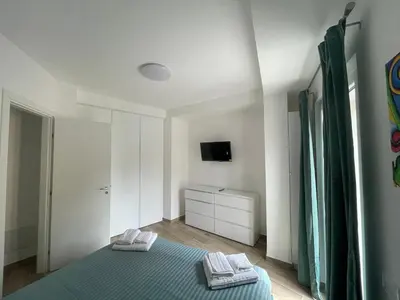 a bedroom with a blue bed with two towels at Casa Himera Palermo in Palermo