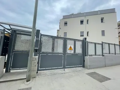 a gate with a caution sign in front of a building at Casa Himera Palermo in Palermo