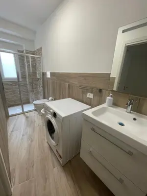 a bathroom with a washing machine and a sink at Casa Himera Palermo in Palermo
