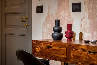 a wooden dresser with two vases on top of it at Art e Dimora - Boutique Room. in Castellammare del Golfo
