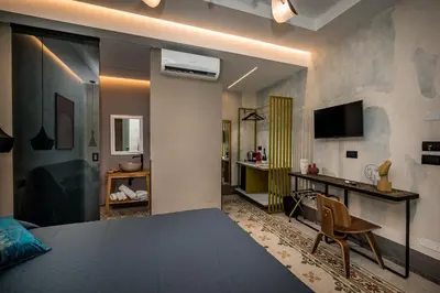 a room with a bed and a desk and a television at Art e Dimora - Boutique Room. in Castellammare del Golfo