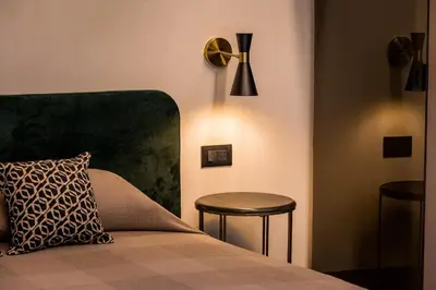 a bedroom with a bed and a table and a stool at Art e Dimora - Boutique Room. in Castellammare del Golfo