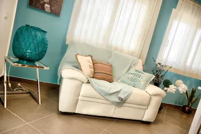 a white chair with pillows on it in a room at Villa Deluxe con Idromassaggio in Palermo