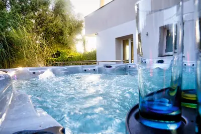 a glass vase sitting on a table in a swimming pool at Villa Deluxe con Idromassaggio in Palermo