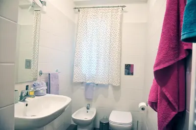 a bathroom with a sink and a toilet at Villa Deluxe con Idromassaggio in Palermo