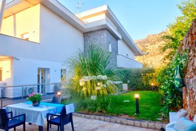 a patio of a house with a table and chairs at Villa Deluxe con Idromassaggio in Palermo