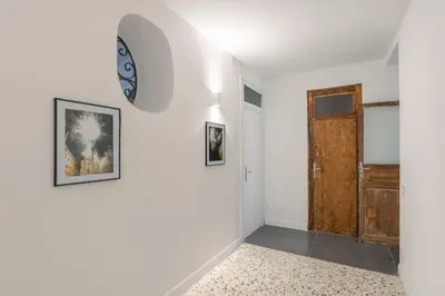 a room with a door and a clock on the wall at 124 Maqueda Apartments in Palermo