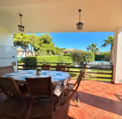 a dining room with a table and chairs on a patio at Villa Jari in Carini