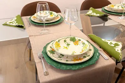 a table with plates and wine glasses on it at Casa Imperia in Palermo
