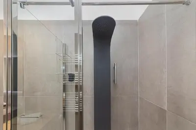 a shower with a black shower head in a bathroom at Casa Imperia in Palermo
