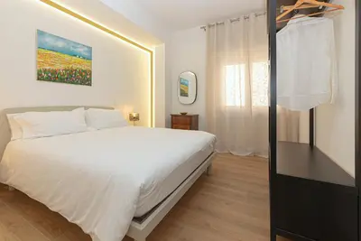a bedroom with a white bed and a window at Casa Imperia in Palermo