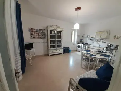 a bedroom with a green bed and a chair at Casa Vacanze Ciccinè in Capaci