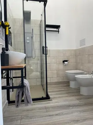 a bathroom with a shower and a sink and a toilet at Casa Lella Holiday Boutique in Palermo