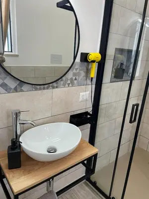 a bathroom with a sink and a mirror at Casa Lella Holiday Boutique in Palermo