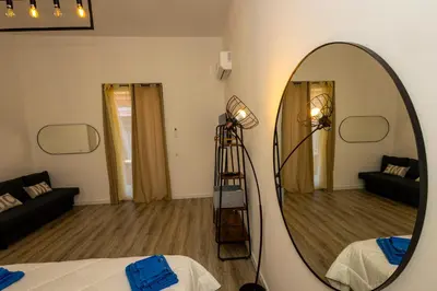 a room with a mirror and a living room at Casa Lella Holiday Boutique in Palermo