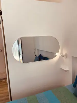 a bedroom with a mirror on the wall at Casa Lella Holiday Boutique in Palermo